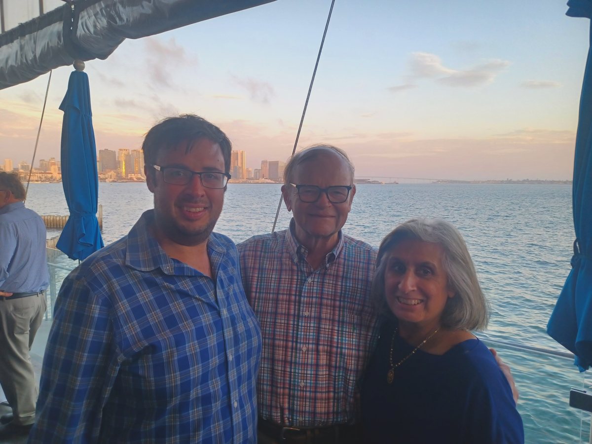 Bob with his son and wife by the water in California at sunset