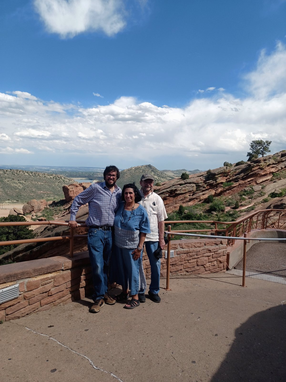 Bob and two family members standing at a railing at Red Rocks in Colorado
